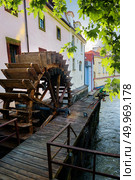 Prague wooden water mill near maple tree. Стоковое фото, агентство Ingram Publishing / Фотобанк Лори
