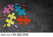 Autism awareness symbol concept and autistic development disorder as a symbol of a communication and social behavior psychology as a puzzle chalk drawing on asphalt in a 3D illustration style. Стоковое фото, агентство Ingram Publishing / Фотобанк Лори