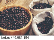 coffee beans on wooden background, arabica coffee, vintage filter image. Стоковое фото, агентство Ingram Publishing / Фотобанк Лори