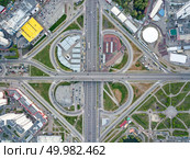Aerial view city of Kiev, a modern road junction with cars, high-rise buildings, shopping centers with parking lots and green areas, Poznyaki district, Ukraine. Photo from the drone. Aerial view modern city of Kiev, a road junction with cars, Ukraine. Редакционное фото, агентство Ingram Publishing / Фотобанк Лори