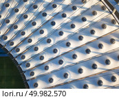 KIEV, UKRAINE - July 19, 2018. Aerial view from drone of the stadium cover structure - NSC Olimpiysky. Elements of the stadium construction. Abstract architecture photo.. KYIV, UKRAINE - July 19, 2018. NSC Olimpiysky. The construction of the stadium roof of National Sports Complex Olympic. Редакционное фото, агентство Ingram Publishing / Фотобанк Лори