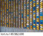 KIEV, UKRAINE - July 19, 2018.Panoramic view from drone of tribunes with yellow and blue seats of National Sports Complex Olimpiysky on a summer day at sunset.. KYIV, UKRAINE - July 19, 2018. Top view of empty blue and yellow seats on a tribunes of NSC Olimpiysky before the soccer game. Редакционное фото, агентство Ingram Publishing / Фотобанк Лори