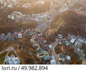 Aerial panoramic view from the drone, bird’s eye view to Vozdvizhenka, Andreevsky descent, National Museum of Ukrainian History at beautiful sunset in the summer.. A bird’s eye view, aerial view shooting from drone of the Podol district, oldest historical center of Kiev, Ukraine. Стоковое фото, агентство Ingram Publishing / Фотобанк Лори