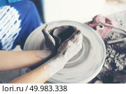 The woman’s hands close up, the masterful studio of ceramics works with clay on a potter’s wheel. Стоковое фото, агентство Ingram Publishing / Фотобанк Лори