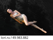 immersion in black waters. Attractive sensual girl in water with reflection of clouds, portrait, fashion, beauty, outdoor, fine art. Стоковое фото, агентство Ingram Publishing / Фотобанк Лори
