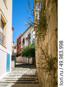 Narrow street in the old town of Palma de Mallorca, Spain. View on Palma de Mallorca streets where many ancient houses and buildings represented.. View on Palma de Mallorca. Стоковое фото, агентство Ingram Publishing / Фотобанк Лори