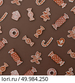 Homemade Gingerbread cookies with different shapes isolated on a brown background. Christmas background. Homemade Gingerbread cookies with different shapes. Стоковое фото, агентство Ingram Publishing / Фотобанк Лори