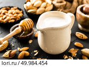 Homemade almond milk in jug. Almond milk and almonds. Стоковое фото, агентство Ingram Publishing / Фотобанк Лори