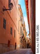 Charming typical village street of Valldemossa, Majorca, Spain. Modern way of life on old Spanish street.. View on Palma de Mallorca. Стоковое фото, агентство Ingram Publishing / Фотобанк Лори