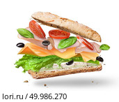 Ciabatta Sandwich with Lettuce, Tomatoes, Ham and Cheese cutted in half flying in the air. Ciabatta Sandwich with Lettuce, Tomatoes, Ham. Стоковое фото, агентство Ingram Publishing / Фотобанк Лори