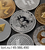 A pattern from different coins of crypto currency, bitcoin, ethereum, litecoin, monero, ripple, dash, against a dark background. Blockchain Technology. Business concept.. Different coins of crypto currency on a black background. Business concept. Стоковое фото, агентство Ingram Publishing / Фотобанк Лори