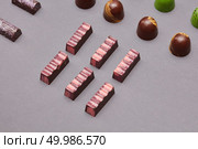 different size chocolate candy on a gray background. Colorful candies background. Стоковое фото, агентство Ingram Publishing / Фотобанк Лори