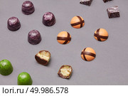 chocolate candy in different sizes and cut on a gray background. Colorful candies background. Стоковое фото, агентство Ingram Publishing / Фотобанк Лори