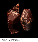 three arched chocolates isolated on a black background. chocolates candies on black background. Стоковое фото, агентство Ingram Publishing / Фотобанк Лори