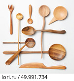 Wooden spoon and knife on a white background. Wooden spoon and knife. Стоковое фото, агентство Ingram Publishing / Фотобанк Лори