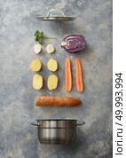 Open pan and sliced vegetables for cooking with baguette on a gray concrete background, flat lay. Saucepan and ingredients for soup. Стоковое фото, агентство Ingram Publishing / Фотобанк Лори