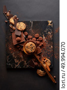 frame of homemade cookies with chocolates and candies on the marble tray and a black background. homemade cookies and chocolates. Стоковое фото, агентство Ingram Publishing / Фотобанк Лори