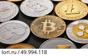 Coins of crypto currency bitcoin, ethereum, litecoin, monero, ripple, dash, on a dark background, a pattern of coins. Business, finance and technology concept.. Set of a coin of crypto currency on a dark background. Business, finance and technology concept. Стоковое фото, агентство Ingram Publishing / Фотобанк Лори