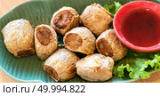 Hoi Jo, Deep Fried Crab Meat Rolls with sweet plum sauce. Thai street food and restaurant cuisine on wooden table. for website banner use. Стоковое фото, агентство Ingram Publishing / Фотобанк Лори