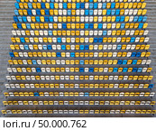 KIEV, UKRAINE - July 19, 2018. National Sports Complex Olimpiysky, aerial view from drone to a tribune with blue and yellow colors in a summer time before match.. KIEV, UKRAINE - July 19, 2018.Panoramic view from drone of tribunes with yellow and blue seats of National Sports Complex Olimpiysky on a summer day at sunset. Редакционное фото, агентство Ingram Publishing / Фотобанк Лори