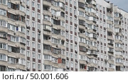 Facade of a residential building with many balconies and windows is showing urban density. Стоковое видео, видеограф Mikhail Davidovich / Фотобанк Лори