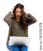 Beuaitful woman in trouble with her laptop, isolated over white background . Стоковое фото, агентство Ingram Publishing / Фотобанк Лори