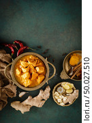 Chicken masala curry, spicy meat. Yellow chicken curry sauce. Spicy chicken curry dish. Traditional indian food, asian cuisine. Top view. Стоковое фото, агентство Ingram Publishing / Фотобанк Лори