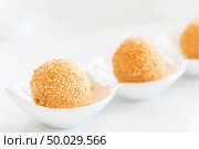 Chinese dim sum Fried sesame balls stuff with custard lava - Chinese groumet cuisine. Стоковое фото, агентство Ingram Publishing / Фотобанк Лори