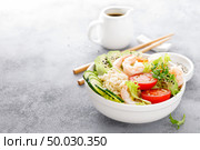 Hawaiian poke bowl with shrimps, rice and vegetables, healthy Buddha bowl with prawns, rice, avocado, cucumber, tomato and lettuce. Стоковое фото, агентство Ingram Publishing / Фотобанк Лори