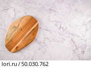 Top view of wooden cutting board on a gray marble background with space for text. Стоковое фото, агентство Ingram Publishing / Фотобанк Лори