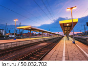 Beautiful night industrial landscape, modern railway station in Nuremberg, Germany. Railroad platform on the background of blue sky. Стоковое фото, агентство Ingram Publishing / Фотобанк Лори