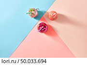 Dietary fresh homemade smoothies from organic vegetables, fruits and berries on a multicolor background of the year 2019 Living Coral Pantone colors. Concept of natural organic healthy food. Flat lay.. Natural organic home smoothies from vegetables and fruits in a glass bottles with plastic straws on a tricolor background of the year 2019 Living Coral Pantone. Top view. Copy space. Стоковое фото, агентство Ingram Publishing / Фотобанк Лори