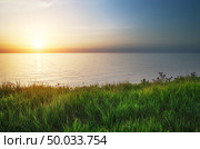 Sundown composition. Sky, sea, and green grass. Стоковое фото, агентство Ingram Publishing / Фотобанк Лори