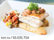 Grilled seabass fish with grilled vegetable on fries. Стоковое фото, агентство Ingram Publishing / Фотобанк Лори