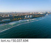 Picturesque seascape with coastline of city Odesa, Ukraine. Cityscape with modern building, sandy beach and blue water. Skyline of clear horizon. Aerial view from drone. Place for text.. Panoramic bird’s eye arial view from drone the coastline of a developed city Odesa, Ukraine. Copy space. Стоковое фото, агентство Ingram Publishing / Фотобанк Лори