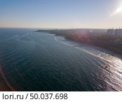 Panoramic bird’s eye arial view from drone the coastline of a developed city Odesa, Ukraine. Cityscape with modern building, skyline of clear horizon. Place for text.. Aerial view from drone marine cityscape of town Odesa, Ukraine on a background of clear blue sky in a sunny day. Copy space. Стоковое фото, агентство Ingram Publishing / Фотобанк Лори