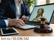 Судья готовится к заседанию за ноутбуком с изображением Фемиды / The judge prepares for the meeting on a laptop with an image of Themis. Стоковое AI-изображение, AI-художник Валерий Лукин / Фотобанк Лори