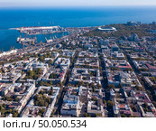 Aerial view from a drone on a panoramic view of the city of Odessa and the sea against a blue sky on a sunny day. Beautiful panoramic view of the sea and part of the city of Odessa on a summer day. Aerial view from the drone. Стоковое фото, агентство Ingram Publishing / Фотобанк Лори