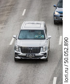 Car GAC GS8 moving on the street. SUV vehicle driving along highway in city with blurred background. Front view from above of Trumpchi GS8 auto. Редакционное фото, фотограф Константин Григорьев / Фотобанк Лори