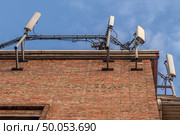 Antennas for mobile telephony on the roof of a residential building and blue sky. Стоковое фото, фотограф Михаил Яковлев / Фотобанк Лори