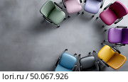 Colorful office chairs arranged in a circle in a modern workspace setting. Стоковое AI-изображение, AI-художник Katsiaryna Repich / Фотобанк Лори