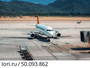 Beautiful white airplane on the runway in Dalaman airport. Landscape with big passenger airplane is taking off and mountains at bright sunny day in summer. Business trip. Commercial aircraft. Travel. Beautiful white airplane on the runway in Dalaman airport. Стоковое фото, агентство Ingram Publishing / Фотобанк Лори