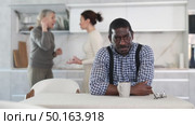 Dissatisfied man is tired of domestic quarrels. Two women quarreling in the background. Стоковое видео, видеограф Яков Филимонов / Фотобанк Лори