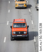 Orange SUV Tank 300 model on the street in motion, aerial frontal view. Редакционное фото, фотограф Константин Григорьев / Фотобанк Лори