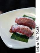 Wagyu beef sushi, japanese groumet cuisine, on white plate. Стоковое фото, агентство Ingram Publishing / Фотобанк Лори