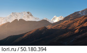 Beautiful mountains with snowy peaks at sunny morning in Nepal. Silhouettes of  Himalayan mountains at sunrise. Colorful landscape with high rocks, blue sky and gold sunbeam. Amazing Himalayas. Nature. Стоковое фото, агентство Ingram Publishing / Фотобанк Лори