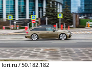 Sage Green Audi RS6 car moving fast on city street, side view. Редакционное фото, фотограф Константин Григорьев / Фотобанк Лори