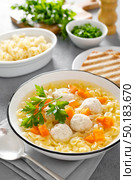 Hot chicken soup, broth with meatballs, carrot, pasta and fresh parsley. Стоковое фото, агентство Ingram Publishing / Фотобанк Лори