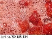Homemade preparation of strawberry jam. Foam and juice when cooking strawberries. The process of making strawberry jam. Close-up of boiling strawberries. Стоковое фото, фотограф Андрей Жигальцов / Фотобанк Лори