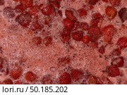 Homemade preparation of strawberry jam. Foam and juice when cooking strawberries. The process of making strawberry jam. Close-up of boiling strawberries. Стоковое фото, фотограф Андрей Жигальцов / Фотобанк Лори